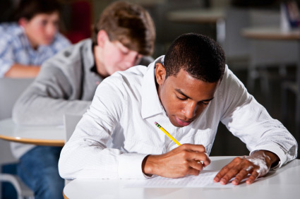 young men sitting exams in school
