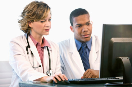 nurse and doctor looking at computer